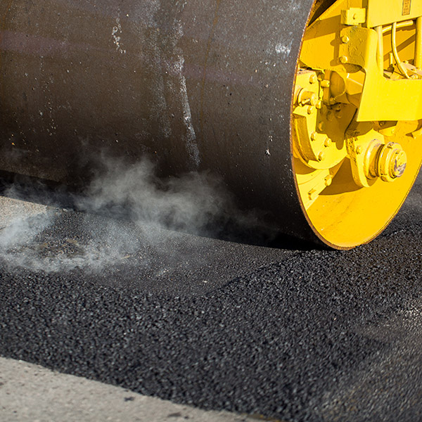 Road roller compacting asphalt