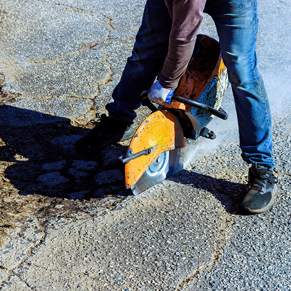 Repairing damaged asphalt cracks before installing new layer asphalt is part of road restoration