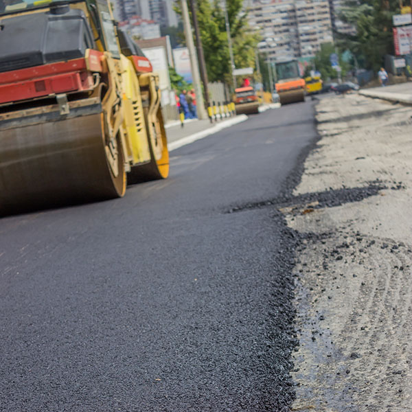 new layer of asphalt, road rollers smoothing out fresh asphalt layer