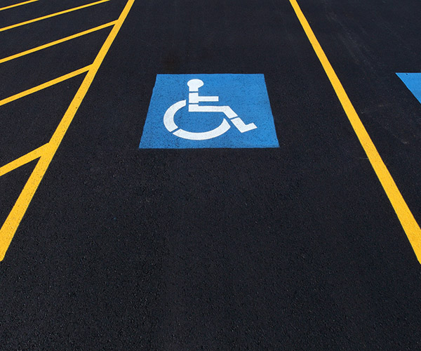 The international markings for a handicapped parking stall in a parking lot.